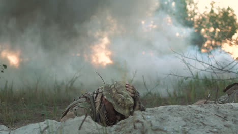 soldiers hiding in a trench during a smoke grenade explosion