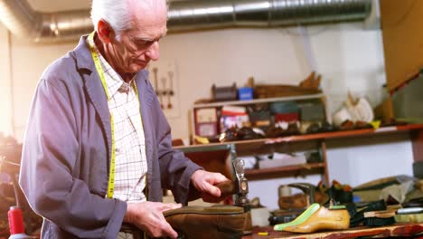 shoemaker hammering on a shoe