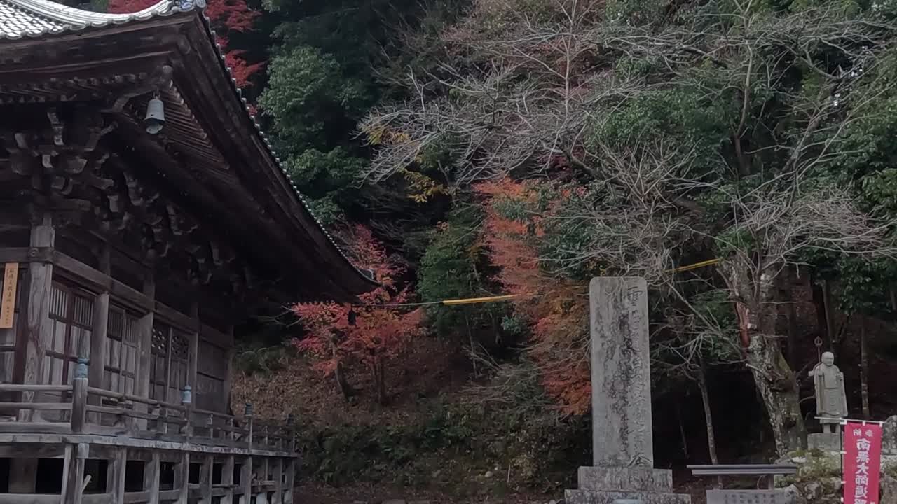 A wooden pavilion amidst vibrant autumn foliage, showcasing traditional architecture and serene natural surroundings.