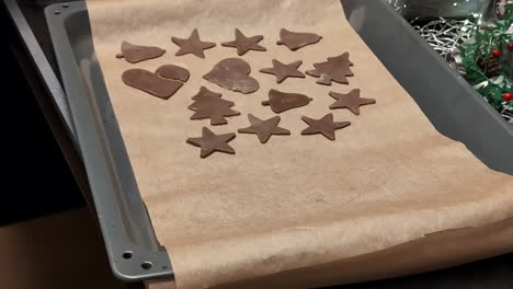 placing raw gingerbread dough on parchment paper ready for baking