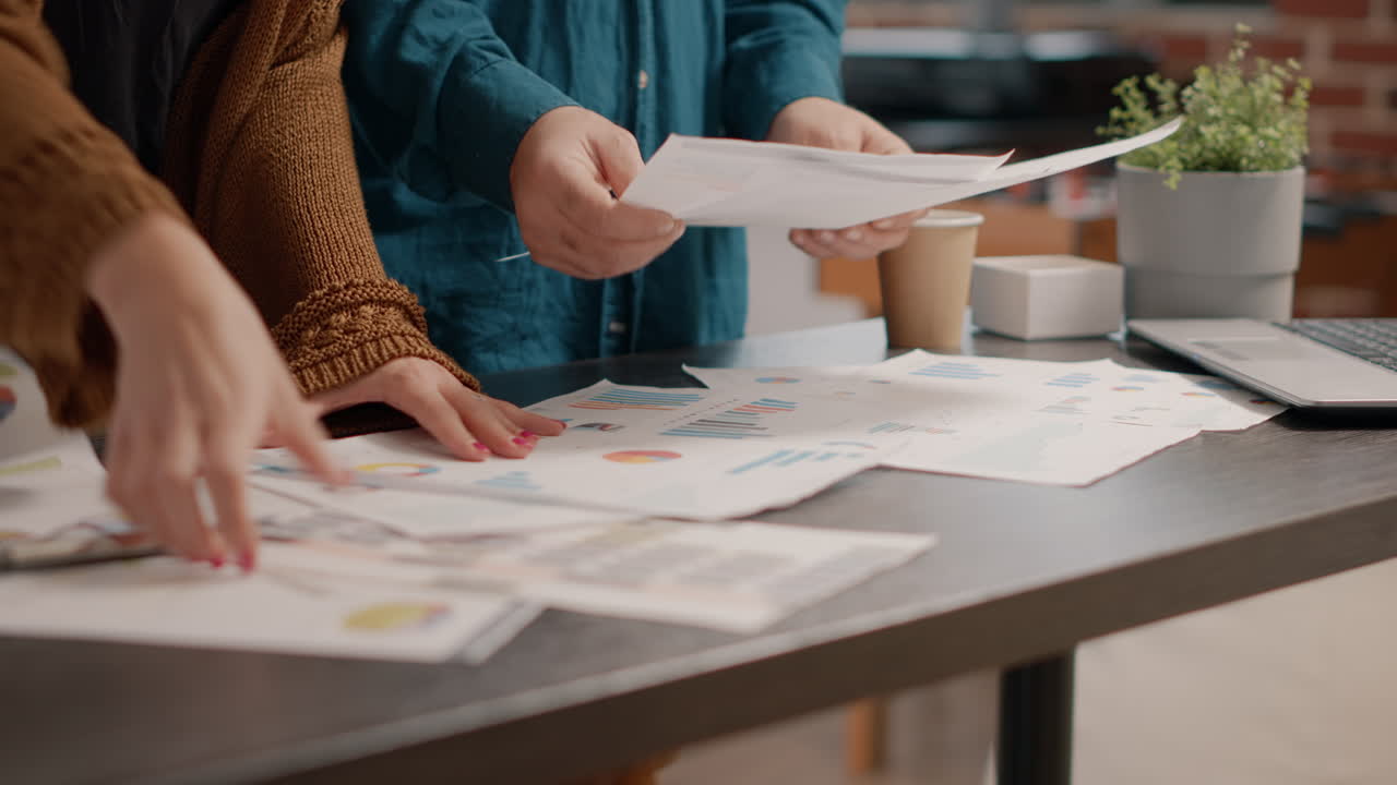 Business meeting at office with charts and documents