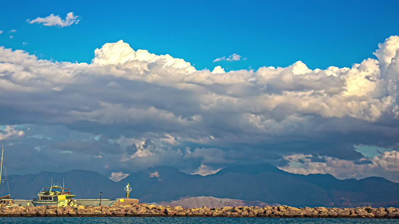 Serene Seascape with Boat and Mountains under a Cloudy Sky