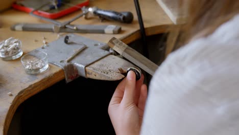 female jewelry designer working in workshop 4k