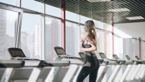 fitness woman training cardio exercise on running machine in gym club.