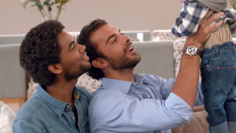 gay smiling couple with their kid