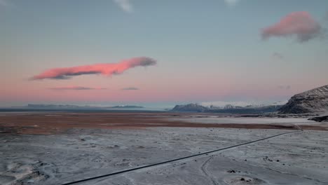 pink sunrise over snowy landscape in winter in oraefi, south iceland