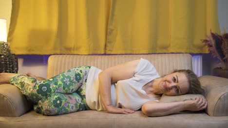 Woman-In-Bed-Laughing-At-Camera.