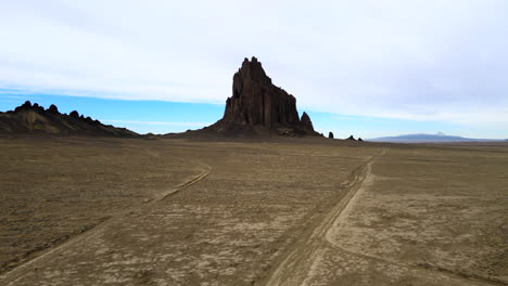 Dirt-Road-Leading-To-Isolated-Shiprock-In-The-Desert-Of-New-Mexico,-USA