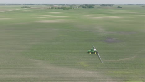 Sprayer Spraying Herbicides On Corn In The Vast Fields. - aerial shot
