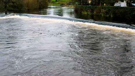 A-4K-reveal-of-the-fast-flowing-River-Suir-flowing-through-Cahir-Town-Centre-Tipperary-Ireland-where-many-Hollywood-films-were-set