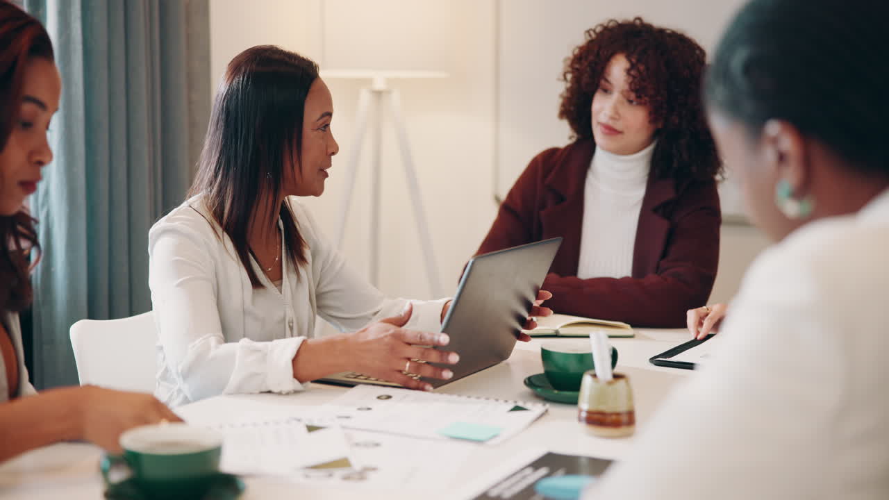 Group of businesswomen discussing a project during a meeting