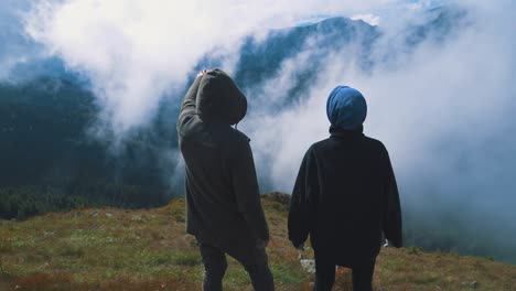 the man and woman standing on the beautiful mountain