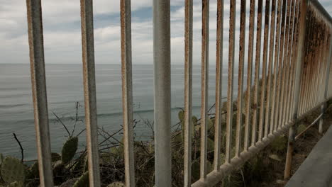 A-view-of-the-Pacific-Ocean-through-the-guard-rail-at-a-vista-point-in-Encinitas,-California