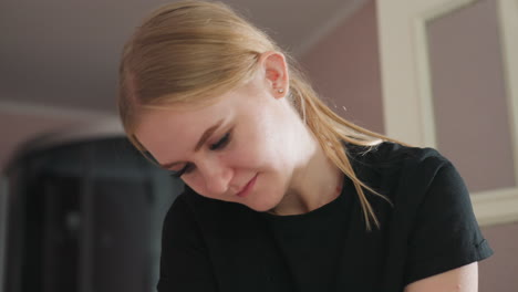 portrait view of massage therapist wearing black shirt, deeply focused while performing therapeutic work in softly lit indoor space, displaying calm concentration and professional dedication