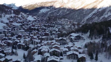 aerial of idyllic winter town in the swiss mountains