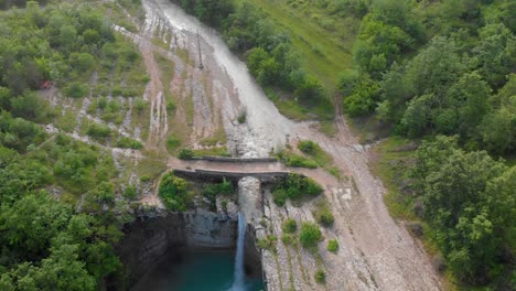 slow reveal of vrapčak creek flowing over waterfall sopot into a deep emerald green pool