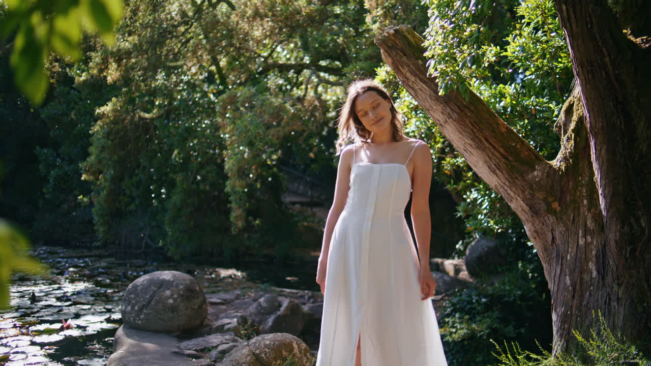 Carefree woman posing sunshine park enjoying calm summer forest nature beauty
