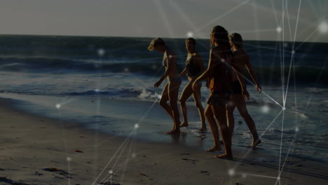 animación de redes de conexiones sobre un grupo feliz de amigos divirtiéndose, caminando por la playa
