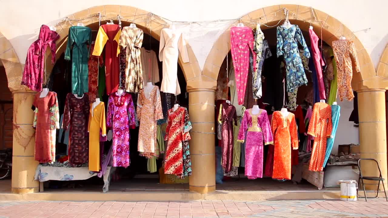 View of arab dresses flapping in the breeze outside a traditional shopping area in Essaouira, Morocco