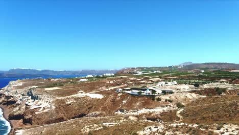 Aerial-4K-Blue-Sea-and-Sky-Top-View-of-Village-of-Akra-Mavro-Vouno-in-Santorini-Greece