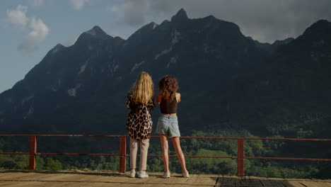 two women enjoying the view from a mountaintop