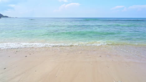 empty exotic tropical beach, turquoise sea, light waves and endless horizon slow motion