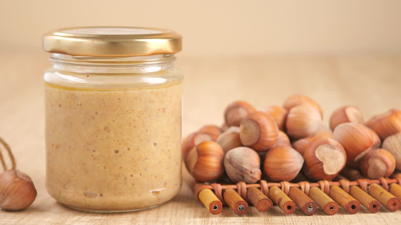 Creamy Hazelnut Butter in a Jar with Fresh Hazelnuts