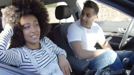 playful young woman goofing around in a car