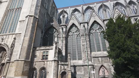 smooth establishing pan of saint bavo cathedral in ghent, featuring its towering gothic spires and facade