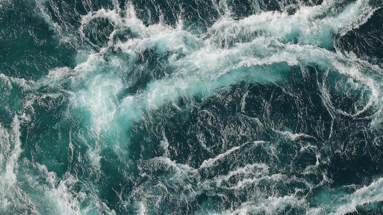 Blue waves of water of the river and the sea meet each other during high tide and low tide.