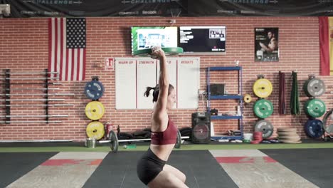 mujer levantando pesas en un gimnasio