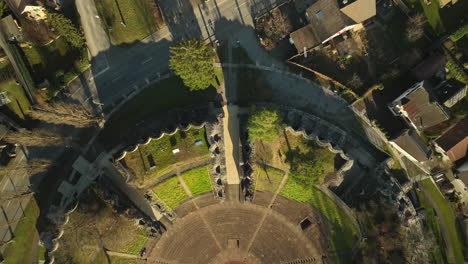 Top-down-drone-dolley-shot-of-the-Augusta-Raurica-roman-theater-on-a-sunny-day