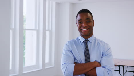 Young-black-businessman-walking-into-focus-in-an-office