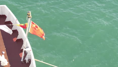 flying in the wind at vessel stern, national flag and emblem of china