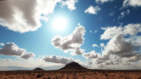 cloud formations over the beautiful dryland of the mojave desert on a bright sunny day - time lapse