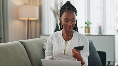 Black-woman,-credit-card-and-laptop-on-sofa