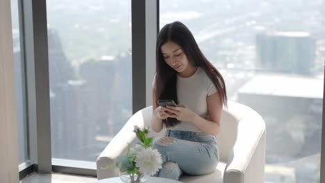 woman using smartphone in a modern cafe