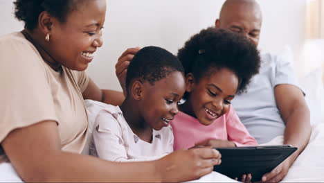 Tablet,-games-and-happy-black-family-in-a-bed