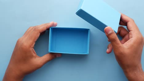 top view of person open a empty small gift box ,