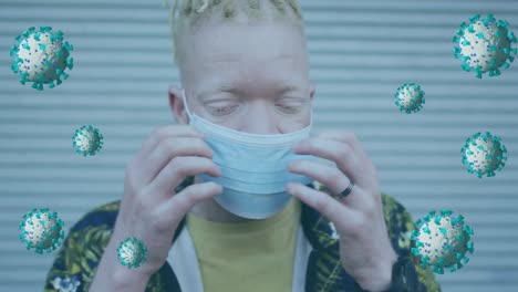 animation of virus cells over albino african american man with face mask