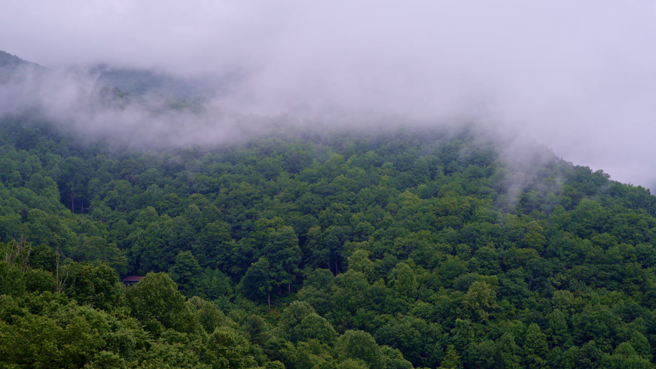 Majestic cinematic drone flyover of misty, foggy Smoky peaks.