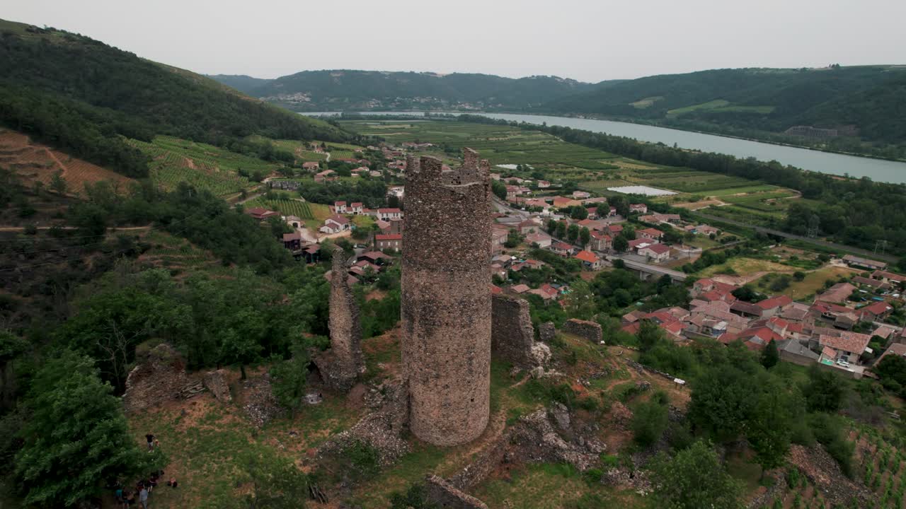 aerial shot around the white tower of Arras Sur Rhone with the town and the Rhone River in the background in Ardeche Departement, Rhone Alpes Region, France