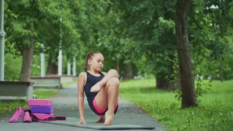 a young girl demonstrating impressive balance and strength during a yoga session in a serene park environment, perfectly capturing focus and commitment