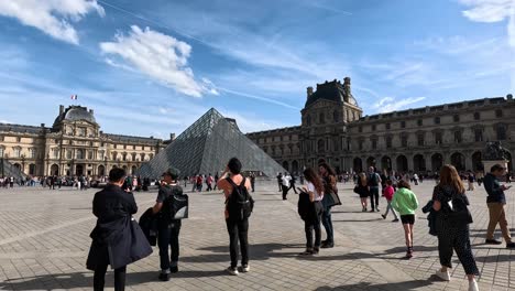 tourists exploring the louvre museum courtyard