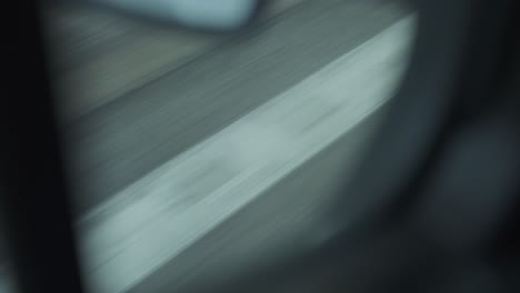 Close-up-of-road-from-moving-car