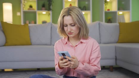 The young girl texting on the phone gets angry and throws the phone.