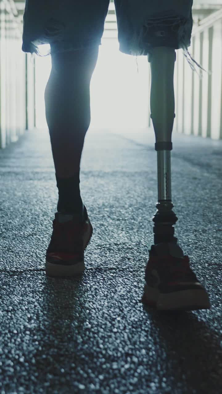Person with prosthetic leg walking in an underground tunnel