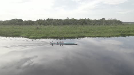 small motorboat sailing in laguna negra, colombia - aerial drone shot