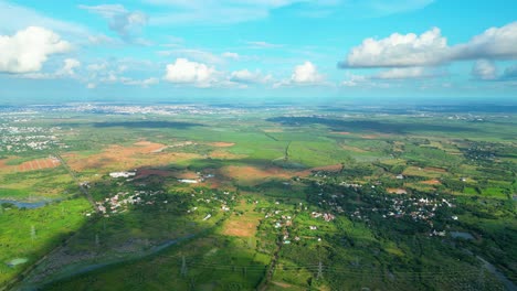 clouds float in sky casting dark blob shadows on countryside of karaikudi tamil nadu india aerial establish