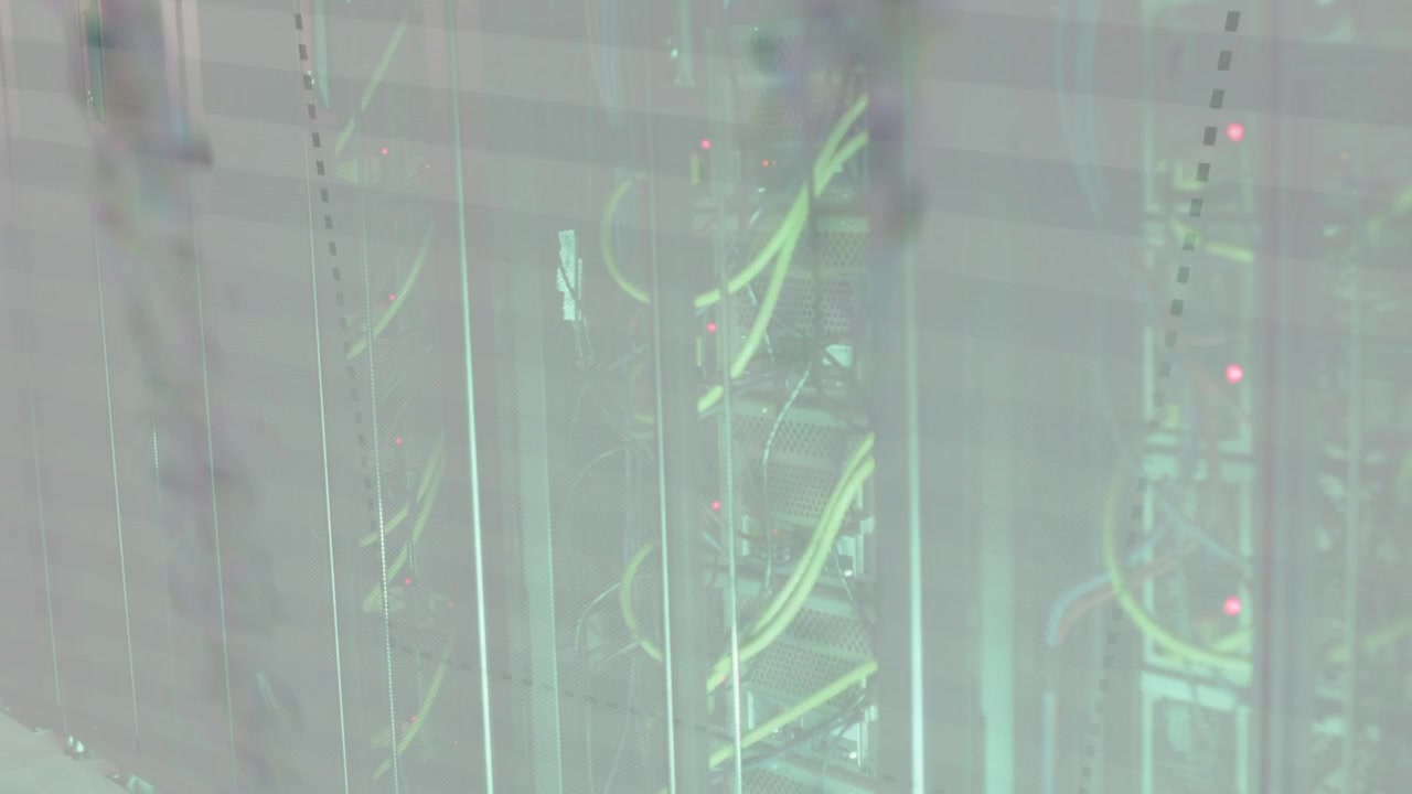 Overlay appearing camera panning across rack showing yellow cables and blinking LEDs for monitoring